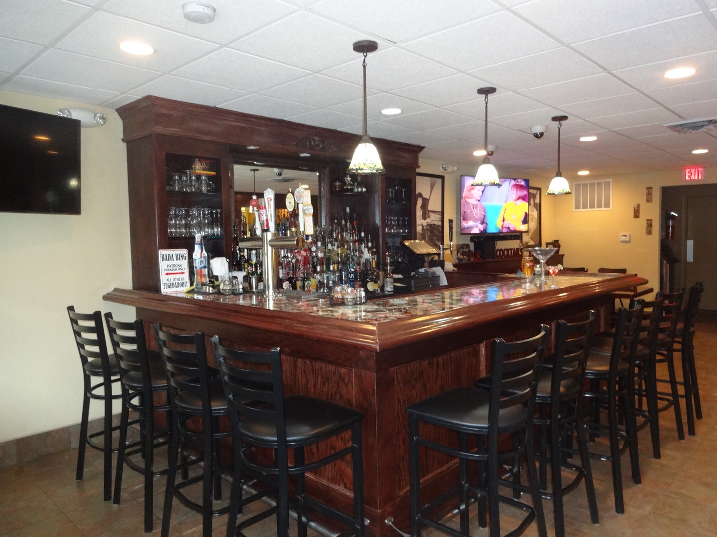 A bar with lots of chairs and lights